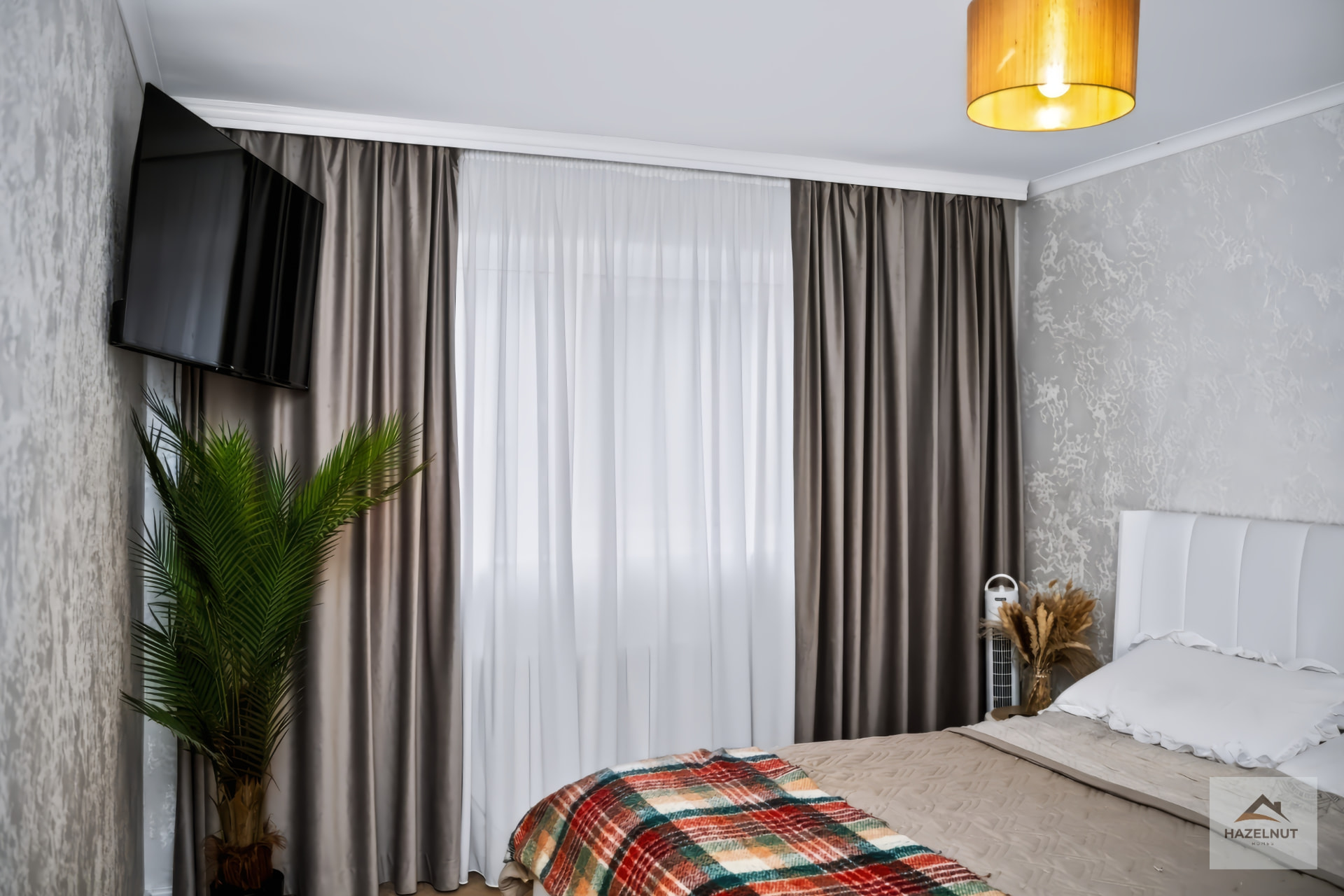 Double bedroom with neutral decor and curtains