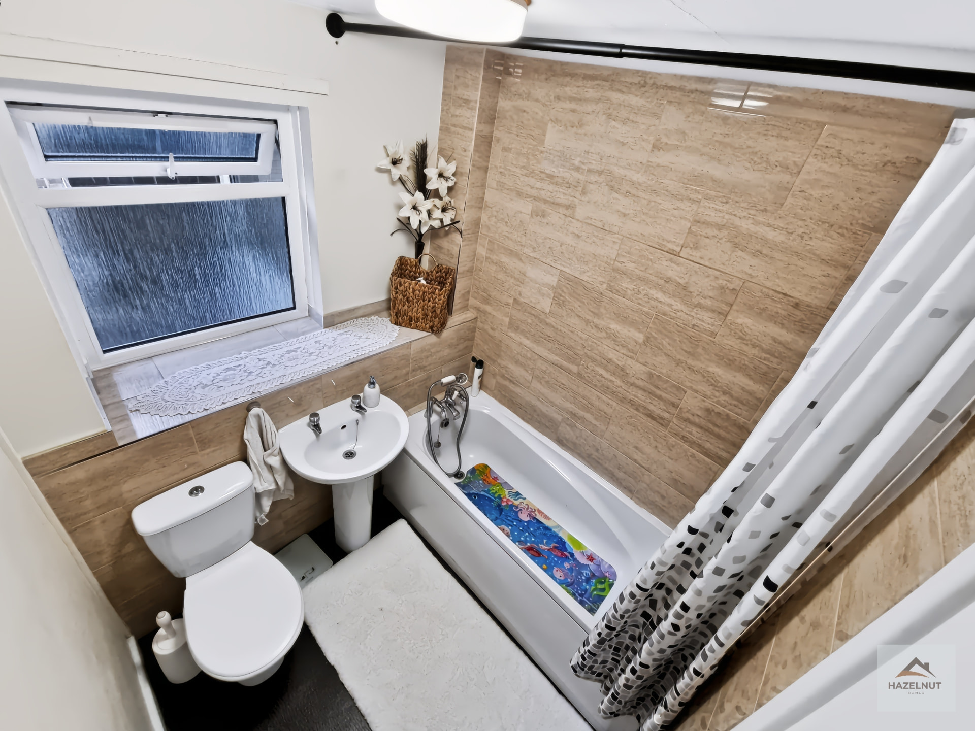 Bathroom with bath and tiled finish